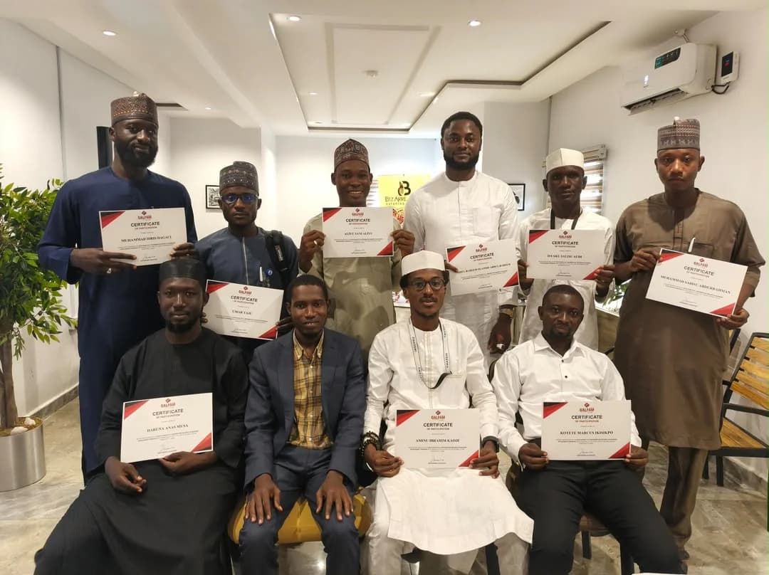 Participants holding certificates of participation at the close of a Universal Pro Consult training programme